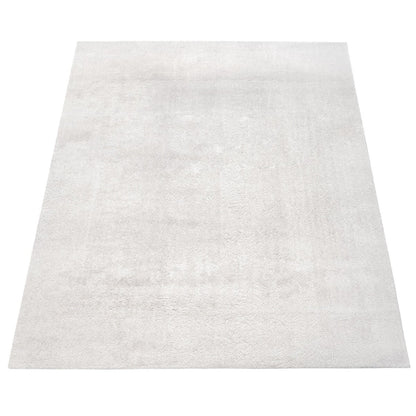 Tapis doux et lavable avec envers antidérapant, disponible en couleurs unies.