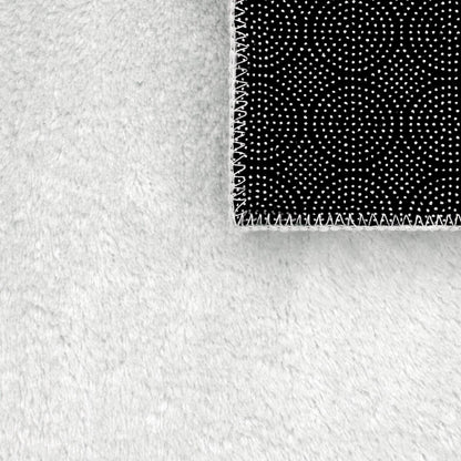 Tapis doux et lavable avec envers antidérapant, disponible en couleurs unies.